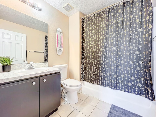 bathroom with tile patterned flooring, a shower with shower curtain, vanity, a textured ceiling, and toilet