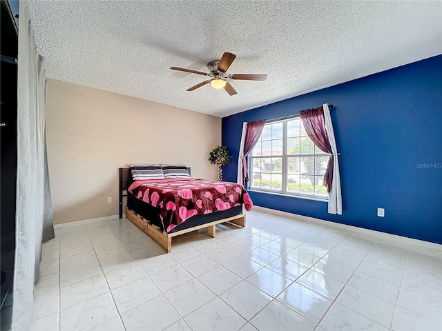 bedroom featuring light tile patterned floors, a textured ceiling, and ceiling fan