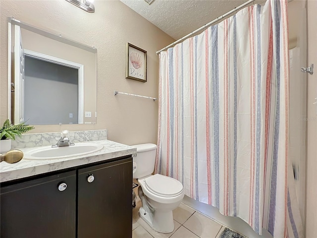 bathroom featuring tile patterned flooring, vanity, toilet, and a textured ceiling