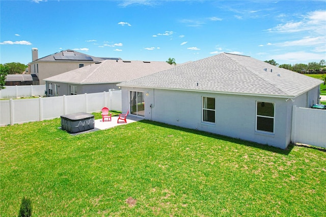 rear view of property featuring a yard and a patio area