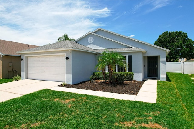 ranch-style home featuring a garage and a front lawn