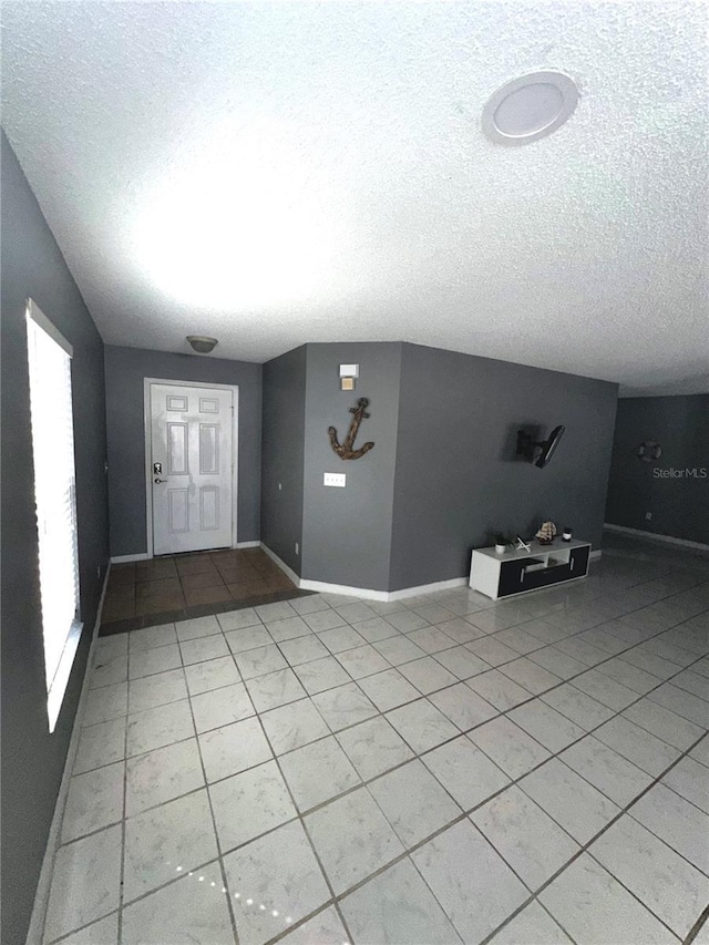 tiled foyer featuring a textured ceiling