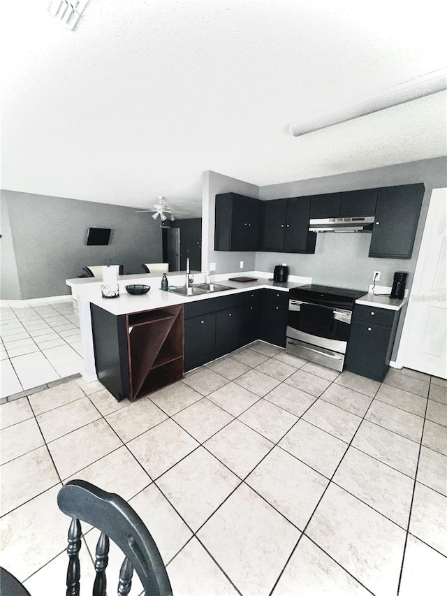 kitchen with sink, stainless steel range with electric stovetop, light tile patterned floors, kitchen peninsula, and dishwasher