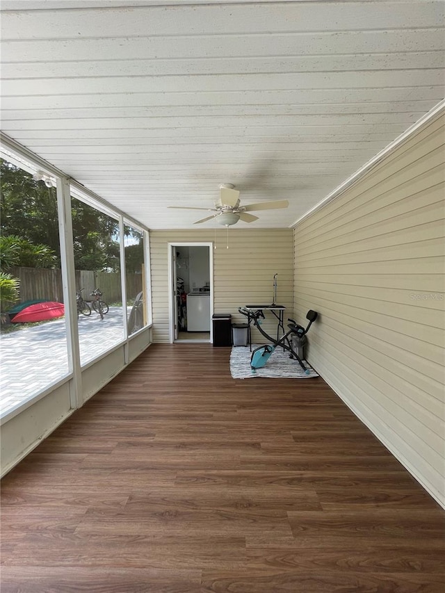 unfurnished sunroom with ceiling fan