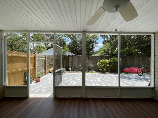 unfurnished sunroom featuring ceiling fan