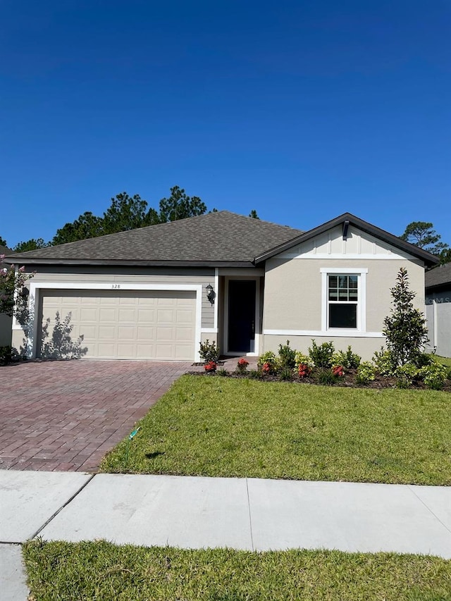 ranch-style house with a front yard and a garage