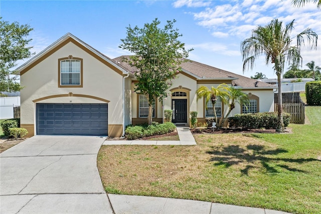 view of front of property with a front lawn and a garage