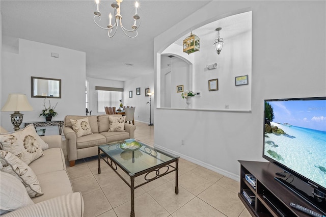 tiled living room with a notable chandelier