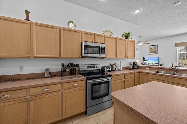 kitchen with ceiling fan, a textured ceiling, light tile floors, sink, and appliances with stainless steel finishes