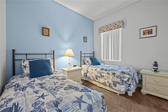 bedroom with vaulted ceiling, dark carpet, and a textured ceiling