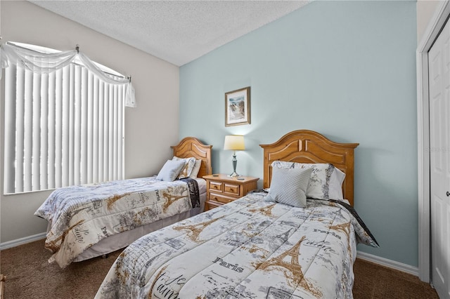 carpeted bedroom featuring a closet and a textured ceiling