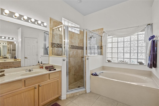 bathroom with tile floors, separate shower and tub, and vanity