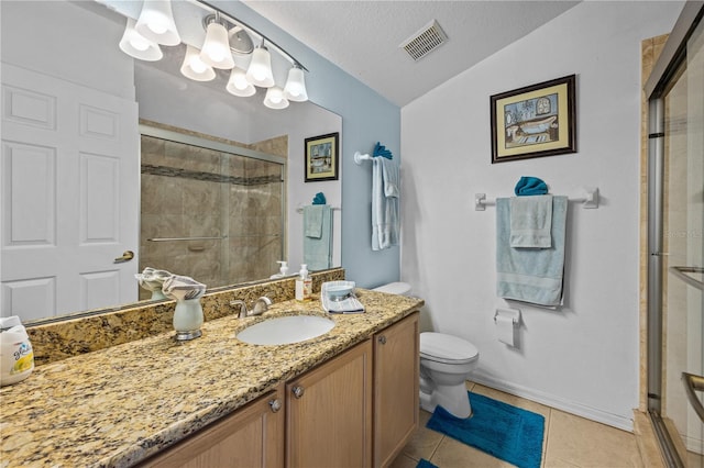 bathroom featuring a textured ceiling, lofted ceiling, tile floors, vanity, and toilet