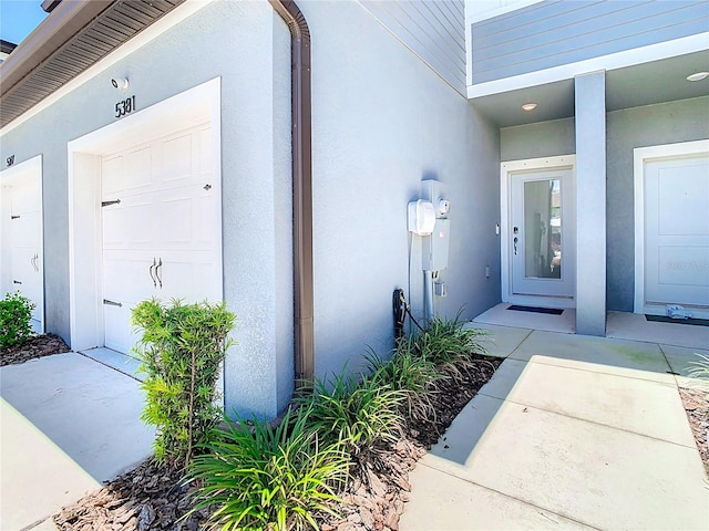 view of exterior entry with a garage