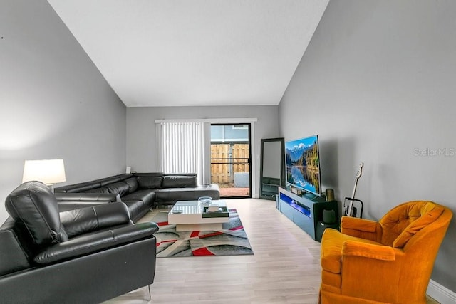 living area with lofted ceiling and wood finished floors