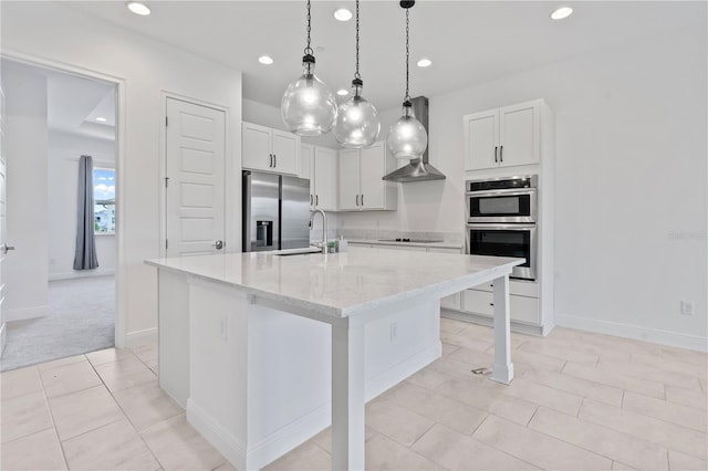 kitchen with light stone counters, an island with sink, appliances with stainless steel finishes, sink, and light tile floors