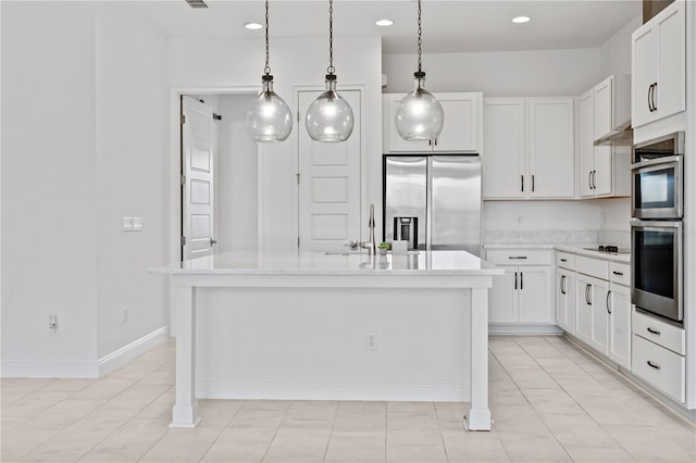 kitchen with stainless steel appliances, white cabinets, a kitchen island with sink, and light tile floors