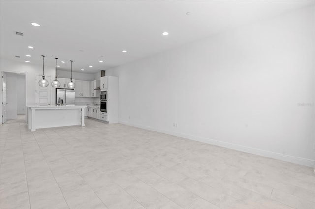 unfurnished living room featuring light tile floors