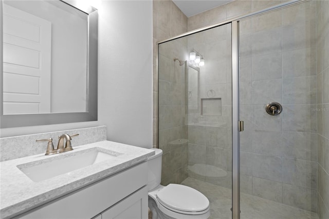 bathroom featuring vanity with extensive cabinet space, walk in shower, and toilet