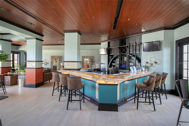 kitchen with wooden ceiling, plenty of natural light, light wood-type flooring, and kitchen peninsula