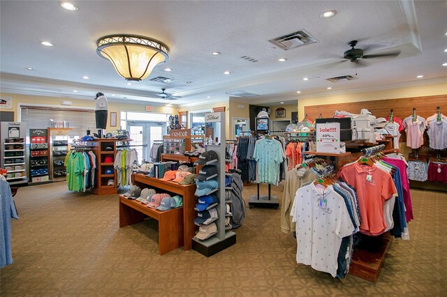 misc room featuring carpet, crown molding, a textured ceiling, a raised ceiling, and ceiling fan