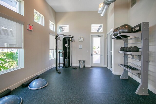 workout area featuring a high ceiling