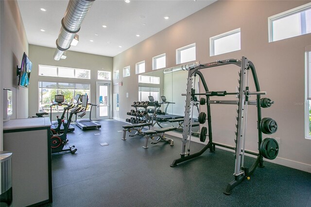 gym featuring a towering ceiling