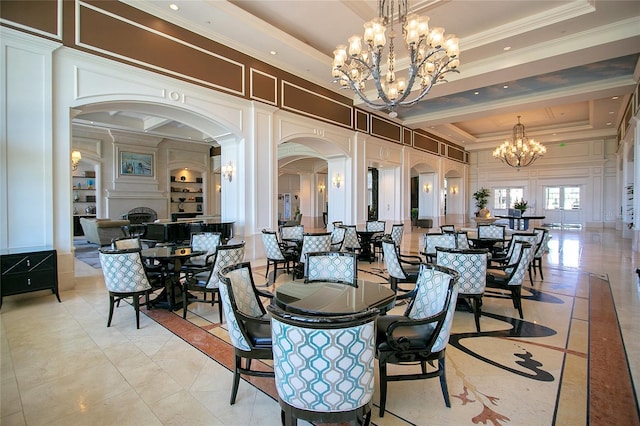 dining space with ornamental molding and a tray ceiling