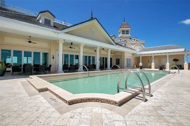 view of swimming pool with ceiling fan and a patio