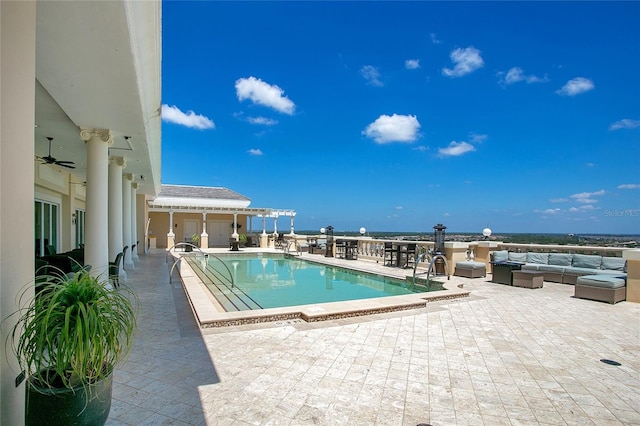 view of pool with a water view, ceiling fan, an outdoor living space, and a patio area