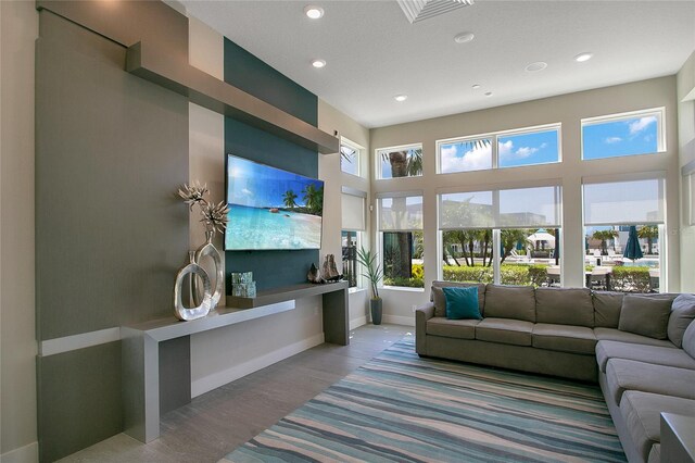 living room with hardwood / wood-style flooring and a high ceiling