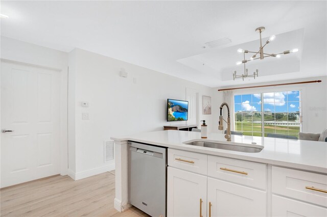 kitchen with stainless steel dishwasher, white cabinetry, sink, and pendant lighting