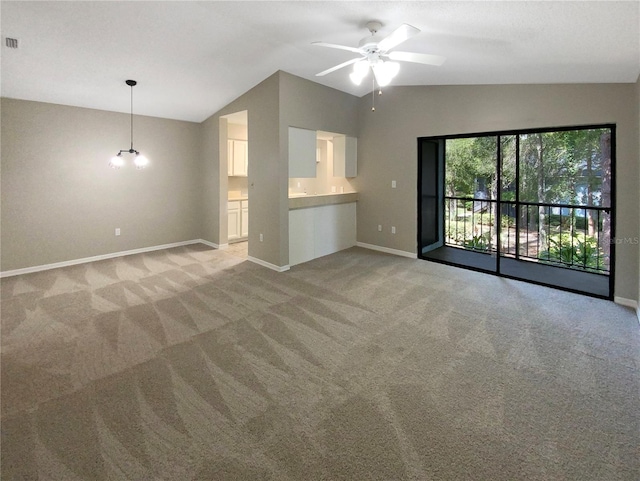 unfurnished living room featuring vaulted ceiling, light carpet, and ceiling fan