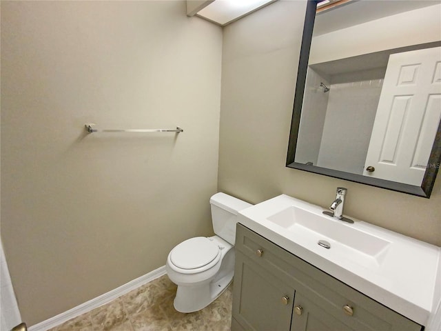 bathroom featuring tile floors, toilet, and vanity