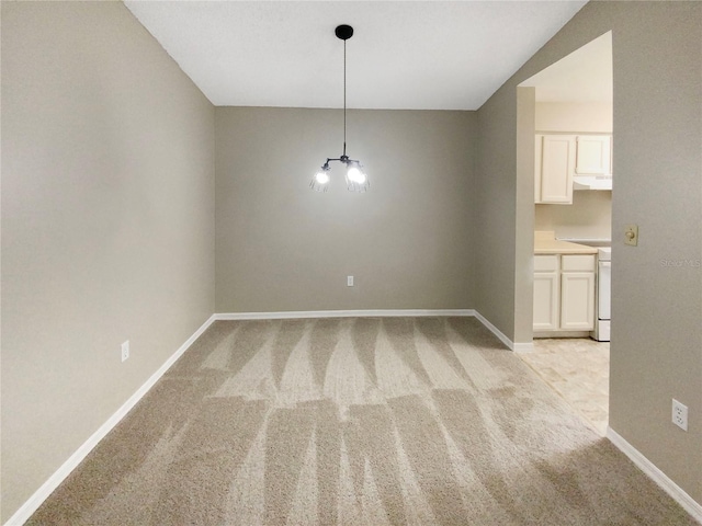 carpeted empty room with lofted ceiling