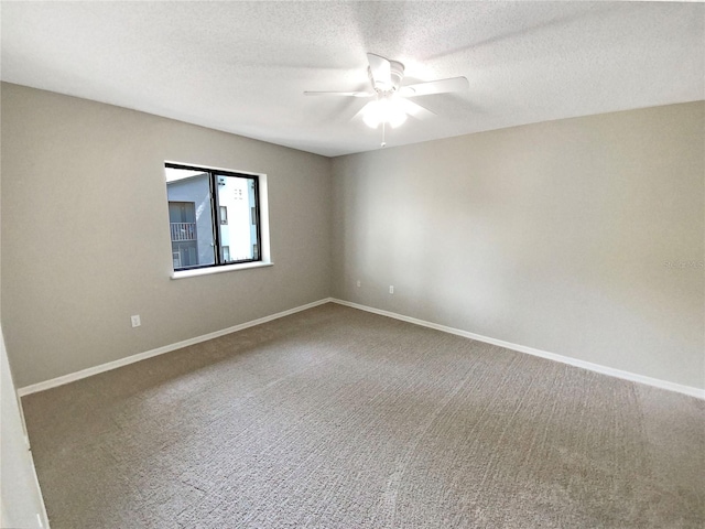 spare room with carpet, ceiling fan, and a textured ceiling