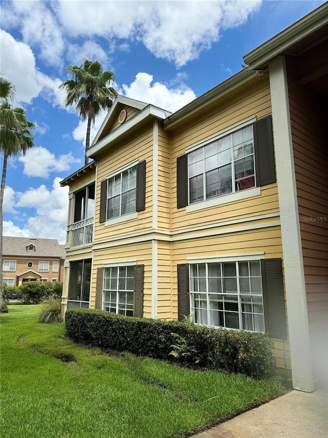 view of property exterior with a yard