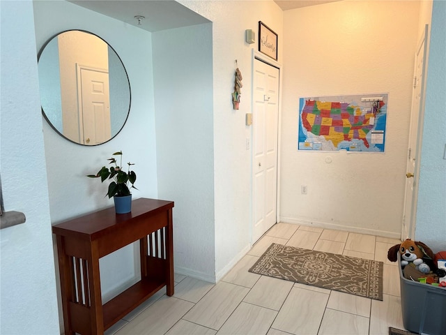 hall featuring light tile patterned floors