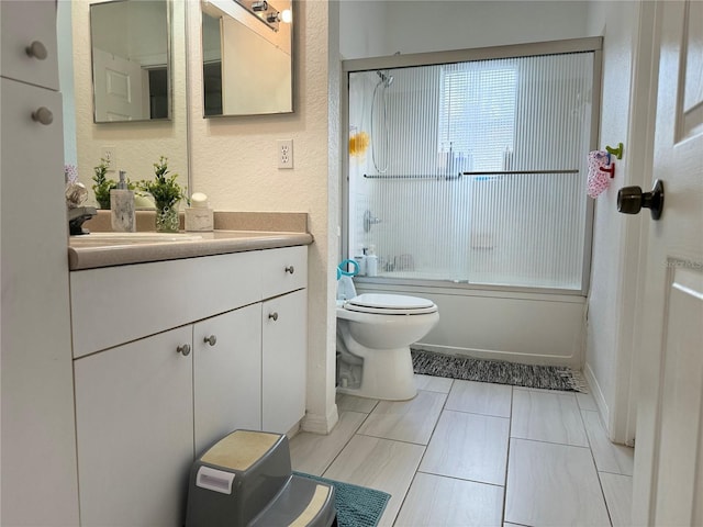 full bathroom with vanity, enclosed tub / shower combo, and toilet