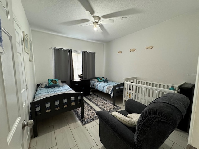 bedroom featuring ceiling fan and a textured ceiling