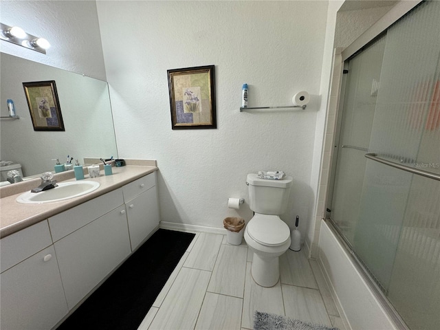 full bathroom with vanity, toilet, and bath / shower combo with glass door