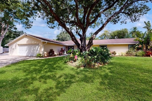 ranch-style house with a garage and a front yard