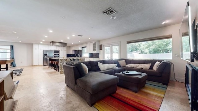 living room with a wealth of natural light and a textured ceiling