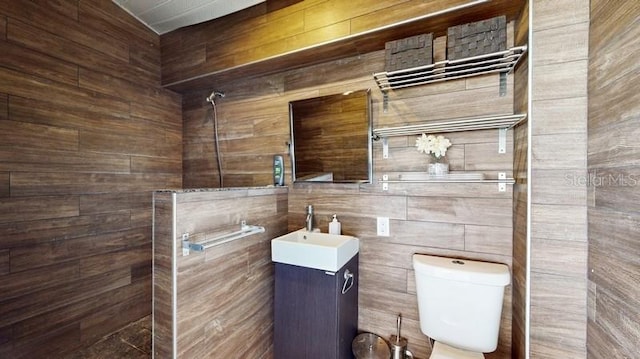 bathroom featuring tile walls, toilet, and vanity