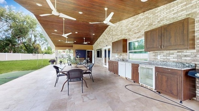 view of patio / terrace featuring area for grilling, ceiling fan, and wine cooler