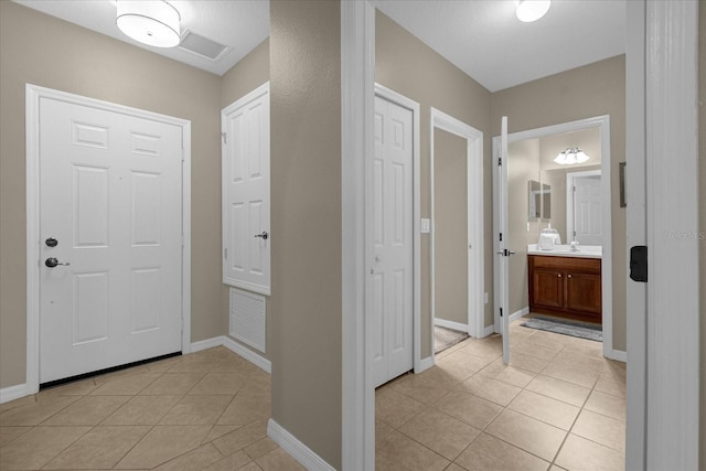 foyer entrance featuring light tile patterned floors