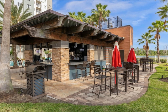 view of patio with a pergola and a bar