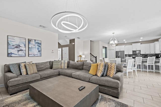 tiled living room featuring an inviting chandelier