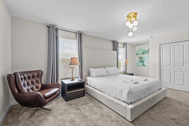 bedroom featuring a closet, carpet floors, and a textured ceiling