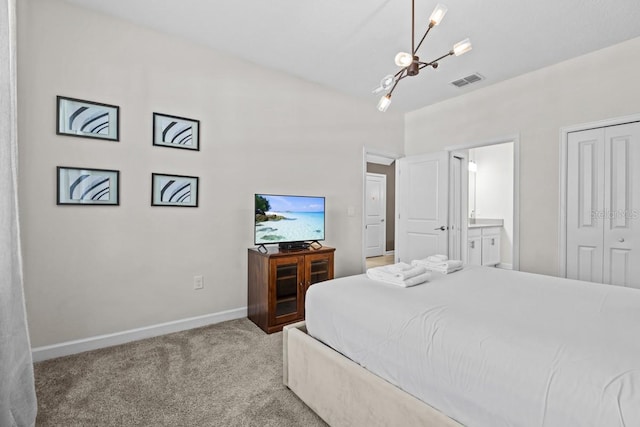 bedroom with a notable chandelier, ensuite bathroom, a closet, and carpet floors